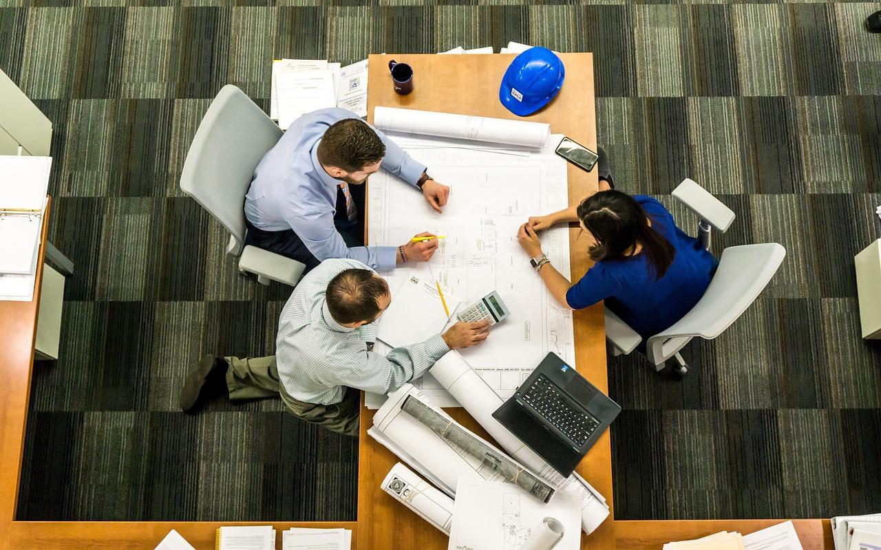 people sat around a desk during a business meeting