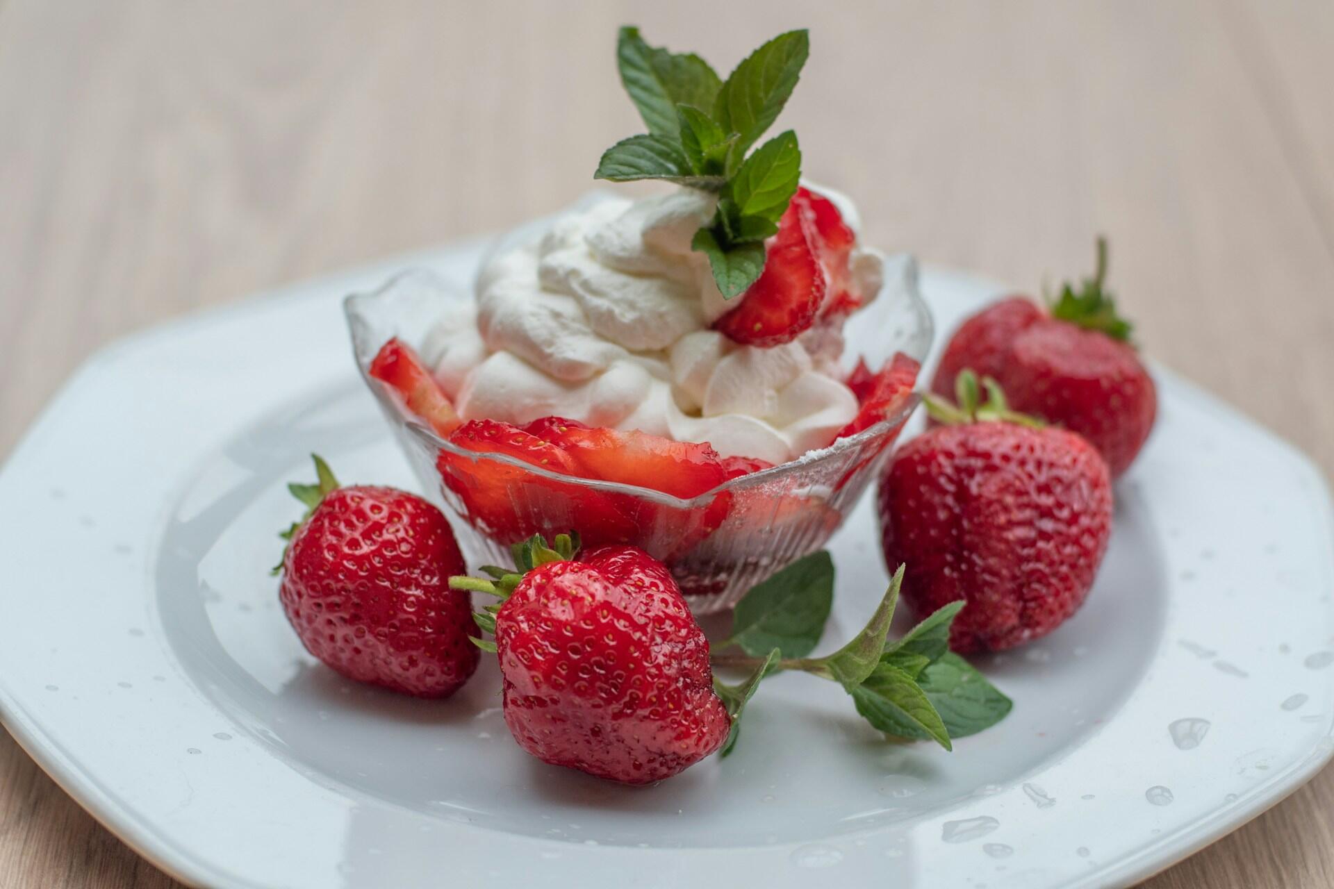 a bowl of strawberries and cream